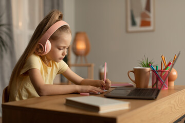 Fototapeta na wymiar Girl Using Laptop Writing Taking Notes At Home, Side View