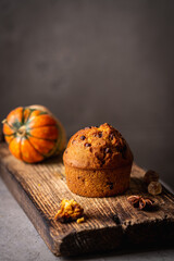 Homemade autumn pumpkin muffins with cinnamon and chocolate