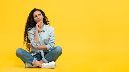 Pensive Female Thinking Looking Aside Sitting Over Yellow Background