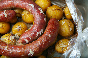 baked potatoes with baked sausages