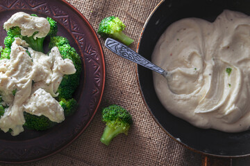 broccoli in a bowl with white sauce