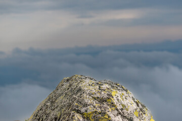 The rock on mountain with clouds behind. Photo from Sonfjället National Park in Sweden.