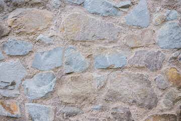 The wall is beige. Decorative brick. The texture of the stone. Abstract background.