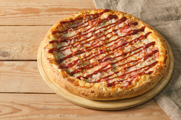pizza on a tray on a wooden background close up
