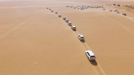 Foto op Canvas 4x4 SUVs cars driving through the sand dunes in the desert of Abu Dhabi. Stock. Top view on SUVs in the desert © Media Whale Stock
