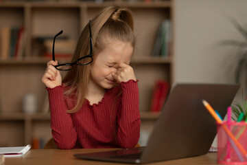 Girl Taking Off Eyeglasses Having Poor Eyesight Near Laptop Indoor