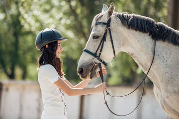 Young teenage girl equestrian having fun with her favorite horse. Dressage outfit