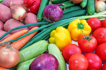 Ripe raw vegetables. Tomato, cucumbers, green onions, avocados, onions, potatoes, carrots, zucchini, bell peppers. Vegetarian healthy natural food and ingredients for eating raw and cooking 