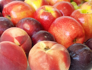 Ripe and juicy fruit. Plums, peaches, grapes, lemons, apples. Vegetarian healthy natural food and ingredients for eating raw as salad, smoothie or juice
