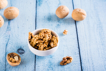 Ripe walnut kernels in a bowl on the table. Organic food.