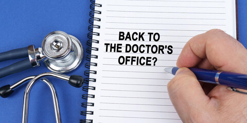 On a blue surface lies a stethoscope and a notebook in which it is written by hand - Back to the...