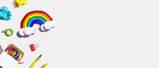 School supplies with a rainbow - overhead view - flat lay