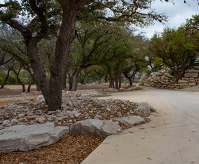 Tree lined driveway that is made out of concrete