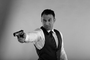 Fototapeta na wymiar Man holding a gun in black and white