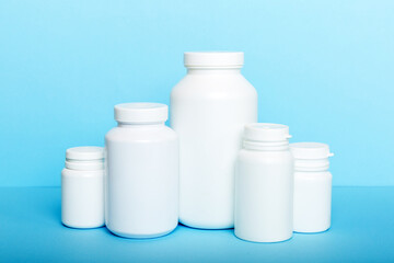 supplement pills with medicine bottle health care and medical top view. Vitamin tablets. Top view mockup bottle for pills and vitamins with green leaves, natural organic bio supplement, copy space