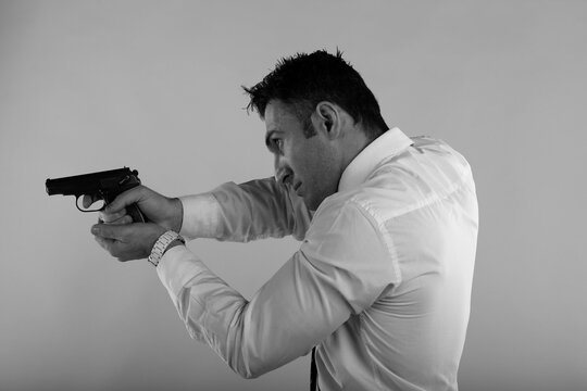 Man holding a gun in black and white