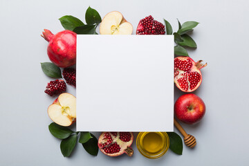 Flat lay composition with Blank flyer poster and symbols jewish Rosh Hashanah holiday attributes on colored background, New Year holiday Traditional. Top view with copy space mock up