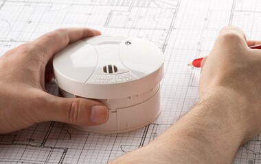 Planing for smoke detector or fire alarm sensor on white architectural plans background, house...