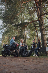 Meeting A company of friends of motorcyclists bikers on motorcycles stopped on the roadside having fun and drinking tea