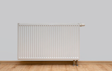 Modern white radiator with thermostat