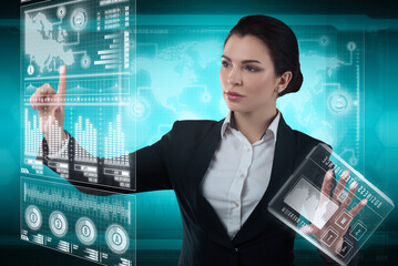 Young business lady works with virtual graphic interface in futuristic office