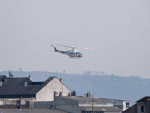 Monforte de Lemos, Lugo, Spain; 07-18-22: Bell 412 helicopter of the Government of Spain flying over the buildings of the city of Monforte during the fire season in Galicia