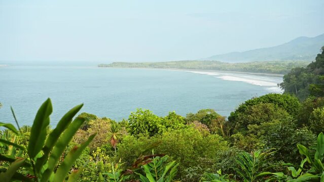Costa Rica Tropical Rainforest Coastal Scenery and Pacific Ocean Landscape on Coast at Ballena Marine National Park (Parque Nacional Marino Ballena), with Uvita Beach, Trees and Mountains