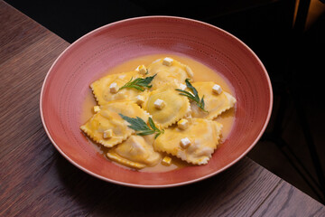 Pasta rellana, raviol ravioles con salsa naranja
