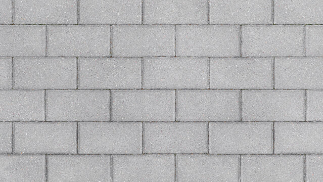 Fototapeta Grey brick wall background close up. Gray stone tile block background with horizontal texture of gray brick. Gray brick surface.