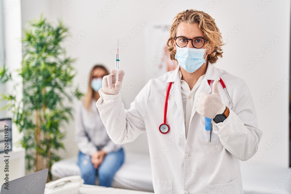 Poster blond man wearing doctor uniform and medical mask holding syringe smiling happy and positive, thumb 