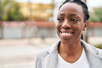 African american woman smiling confident looking to the side at street