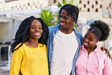 African american friends smiling confident hugging each other at street