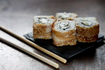 Japanese food rolls with fish and avocado.