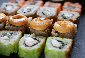 Japanese food. Sushi. Philadelphia roll with fresh salmon, cucumber, avocado, cream cheese, tobiko caviar.