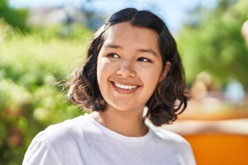 Young woman smiling confident looking to the side at park