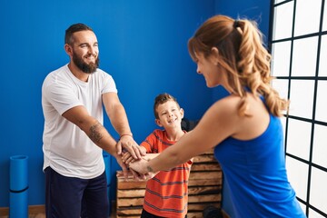 Obraz premium Family smiling confident with hands together at sport center