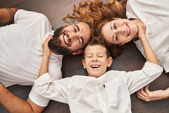 Family smiling confident lying on floor at home