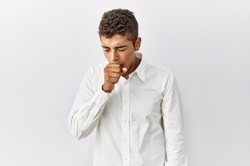 Young handsome hispanic man standing over isolated background feeling unwell and coughing as symptom for cold or bronchitis. health care concept.