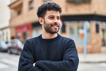 Young arab man smiling confident standing with arms crossed gesture at street