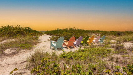 Beach and ocean scenics for vacations and summer getaways. Colorful chairs near beach.