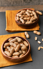 Image of bunch of peanuts in a bowl on a slate surface