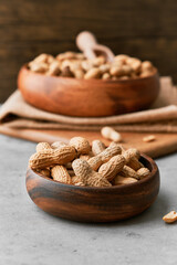 Image of bunch of peanuts in a bowl on a concrete surface