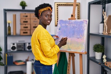 Young african american woman artist smiling confident drawing at art studio