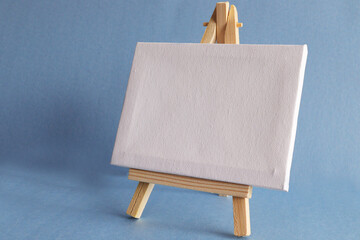 Blank miniature canvas on easel with large Copy Space