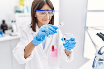 Young hispanic girl working at laboratory