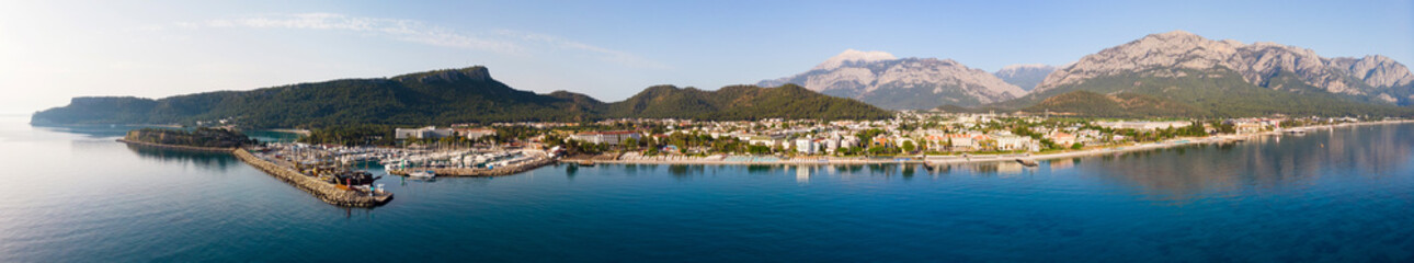 Fototapeta na wymiar Panoramic photo of Kemer, resort town on Mediterranean coast of Turkey. City on Turkish Riviera from above.