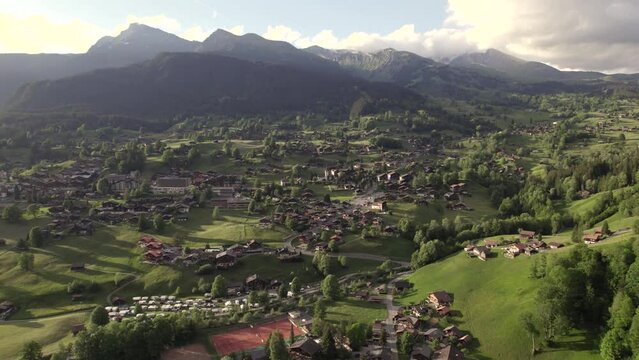 aerial drone footage dolly right to left of beautiful sunset view of grindelwald village in the swiss alps