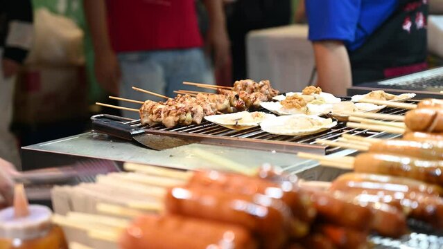 A street vendor is preparing food for their customer at Jonker Street, Malaysia.