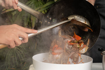 Fototapeta premium Friends putting warm cooked food in a container