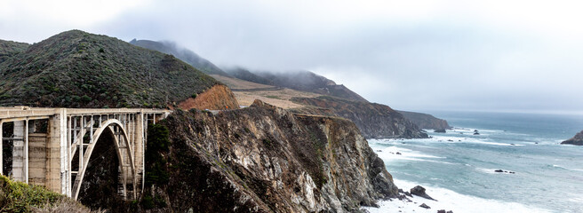 Bixby Bridge along Big Sur Rocky Coastline with Pacific Ocean Waves and Cloudy Sky © Wendy